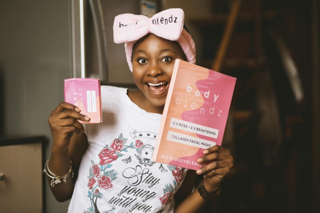 Happy woman holding Body Blendz skincare products with joy and excitement.