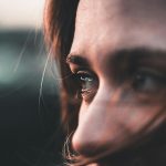 A stunning close-up portrait capturing deep emotions in a warm sunset light.